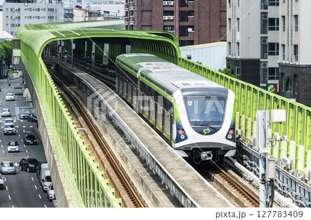 A Green Line train running on the elevated track of the Taichung Rapid Transit System in Taiwan.  127783409