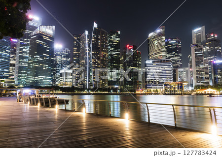 Night view of modern skyscrapers along Marina Bay in the Raffles Place financial district from the Marina Bay Sands observation deck, Singapore. Night view of modern skyscrapers along Marina Bay in the Raffles Place financial district from the Marina Bay Sands observation deck, Singapore. 127783424