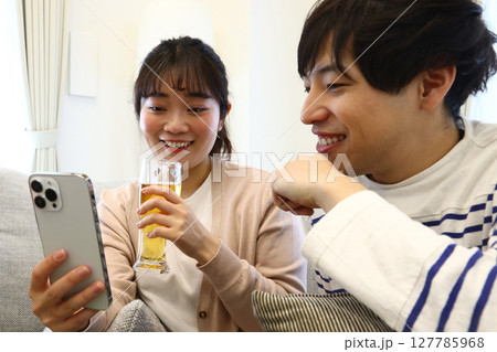 スマホを見るカップル 127785968