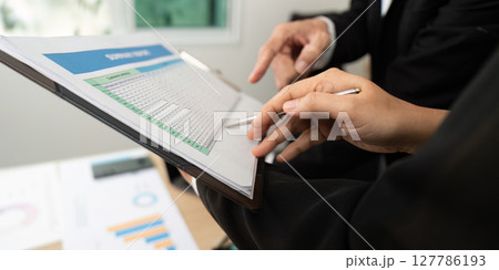 Data Review and Strategy Development. Business professionals analyzing financial data together. Data Review and Strategy Development. Business professionals analyzing financial data together. 127786193