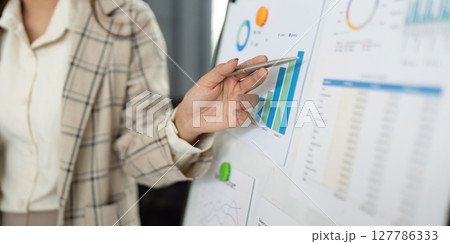 Data Presentation. Professional showcasing financial growth on a chart. Data Presentation. Professional showcasing financial growth on a chart. 127786333