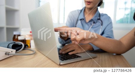 Doctor-Patient Interaction. Healthcare professional guiding patient through online health consultation. 127786426