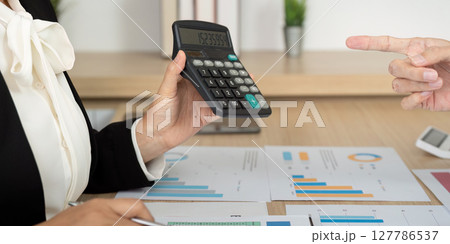 Accounting Consultation with Calculator. Business professional analyzing financial data. Accounting Consultation with Calculator. Business professional analyzing financial data. 127786537