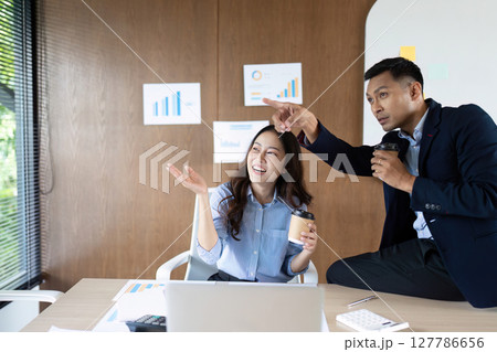 Collaboration and Success. Business team celebrating achievements in modern office. 127786656