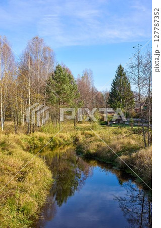 Tranquil view of the river bank in autumn Tranquil view of the river bank in autumn 127787352