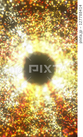 Bright circular void surrounded by sparkling particles in red, orange, and yellow hues, evoking a fiery portal 127788414