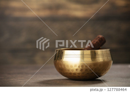 Golden Singing Bowl for Meditation on Rustic Background Golden Singing Bowl for Meditation on Rustic Background 127788464