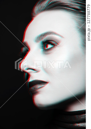 Close-up studio portrait of woman with fancy make-up in RGB color split effect style Close-up studio portrait of woman with fancy make-up in RGB color split effect style 127788779