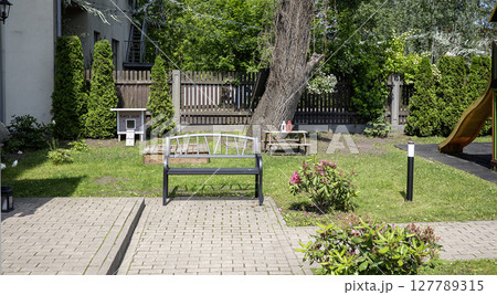 Metal bench in the park on a sunny day 127789315