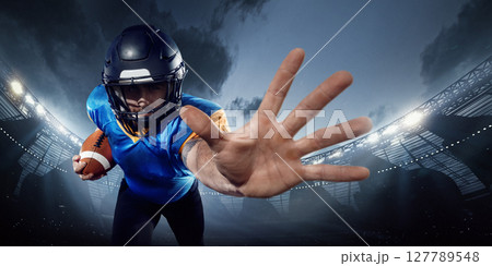 American football player in helmet extends hand in defense at 3D stadium. Athlete performance American football player in helmet extends hand in defense at 3D stadium. Athlete performance 127789548