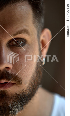 Bold dopamine. Close up man with gloss and dark eyeshadow. Confident and bold. Bold dopamine. Close up man with gloss and dark eyeshadow. Confident and bold. 127790436