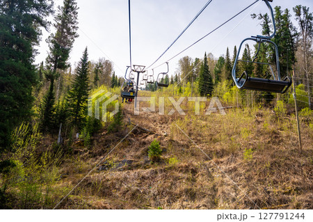 A ski lift to Mount Kokuya at the Teletskoye ski resort. A ski cable car carries tourists in Altai, Russia. A ski lift to Mount Kokuya at the Teletskoye ski resort. A ski cable car carries tourists in Altai, Russia. 127791244