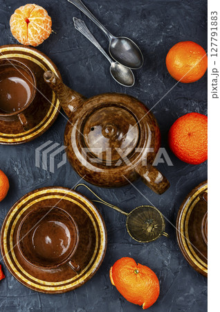 Glass kettle of tangerines tea. Glass kettle of tangerines tea. 127791883