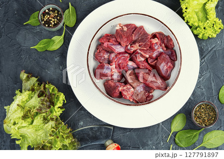 Sliced raw venison deer meat. 127791897