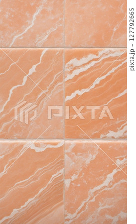 Orange marble tiles with natural veins and texture. Polished ceramic stone surface for flooring, wall covering, architecture, and interior design 127792665