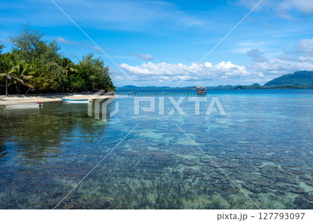 Wooden jetty and boat at Bolilanga Island, Togian archipelago, Sulawesi, Indonesia Wooden jetty and boat at Bolilanga Island, Togian archipelago, Sulawesi, Indonesia 127793097