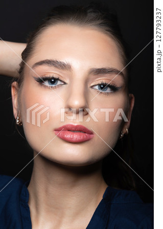 Beautiful woman with day make-up close-up studio portrait 127793237