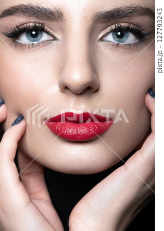 Beautiful woman with make-up and red lips studio portrait 127793243