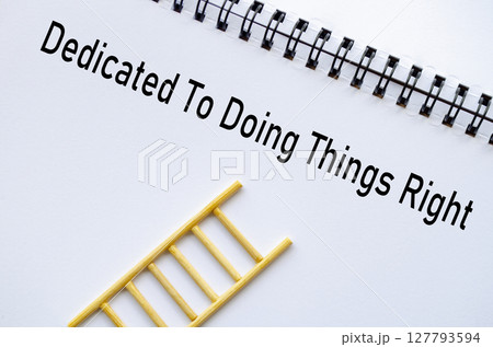 Dedicated To Doing Things Right on notebook with ladder symbolizing ethics and values 127793594