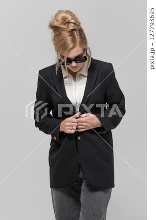 Beautiful woman with black suit and sunglasses studio portrait portrait 127793695