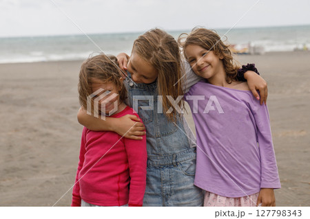 Kids outdoors. Little girls friends hugging outdoor. Child 7, 8 and 10 years old portrait Kids outdoors. Little girls friends hugging outdoor. Child 7, 8 and 10 years old portrait 127798343