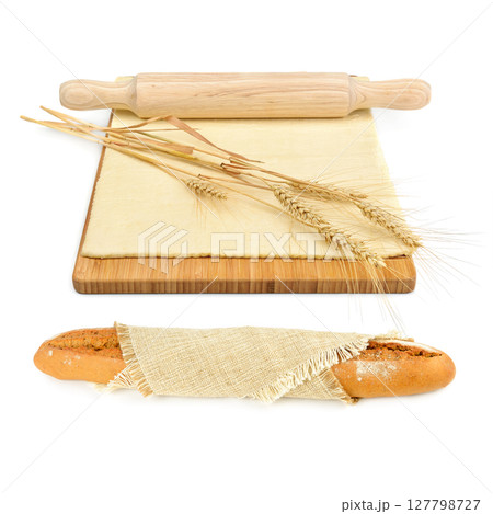 Freshly baked baguette, dough and rolling pin isolated on white. Collage. 127798727