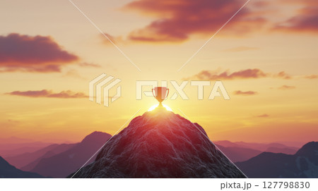 Glowing trophy atop mountain peak under vibrant sunrise symbolizing motivation and achievement 127798830