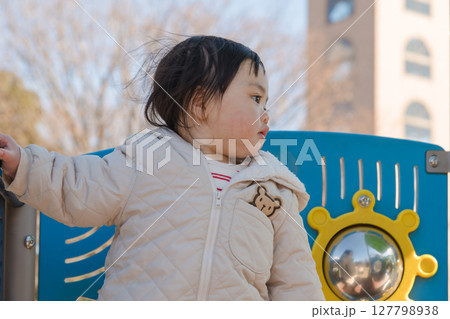 【相模原市立麻溝公園の子どもの広場の滑り台で遊ぶ1歳児】 127798938