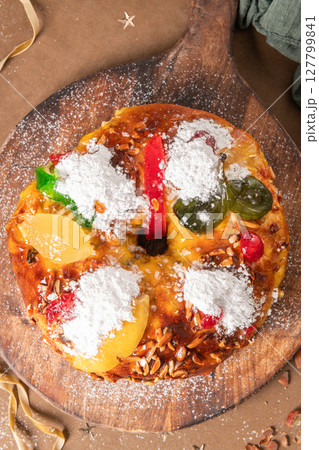 Bolo do Rei or King s Cake, Made for Christmas, Carnavale or Mardi Gras with Christmas season elements in Background. 127799841