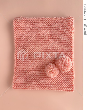 Soft pink lace knitted round scarf isolated on pastel pink background. Fashion children's accessory. 127799844