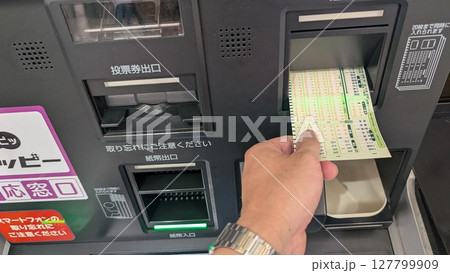 馬券を購入する手元の様子｜自動発売機での操作シーン 127799909