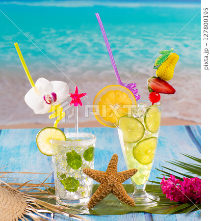 Mojito and lemon lime Cocktails in tropical blue wood Mojito and lemon lime Cocktails in tropical blue wood 127800195