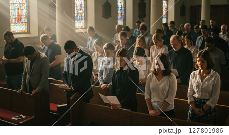 Asian Man in White T-Shirt Showing Gratitude with Praying Hands - Peaceful and Respectful Expression for Mindfulness or Wellness Concept 127801986