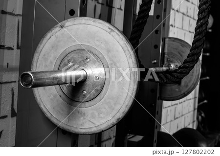 Barbells in a gym bar bells and rope 127802202
