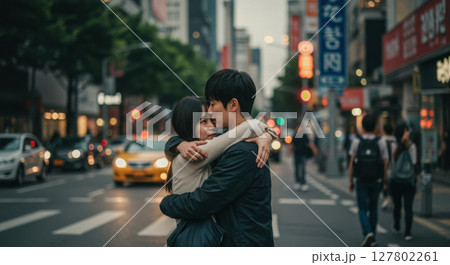Romantic Asian Couple Hugging in the Middle of a Busy City Street 127802261