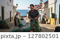 Happy Fisherman Repairing Nets in a Coastal Village Street Near the Sea 127802501