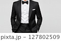 Elegant Man in Classic Black Tuxedo with Bow Tie and White Shirt on Light Background 127802509
