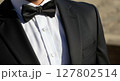 Close-Up of Elegant Black Tuxedo and Bow Tie in Sunlight 127802514