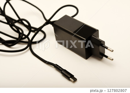 A new charger for gadgets with a wire. USB charging with a wire. A new charger for gadgets with a wire. USB charging with a wire. 127802807