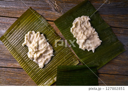 Tamale preparation Mexican recipe banana leaves 127802851