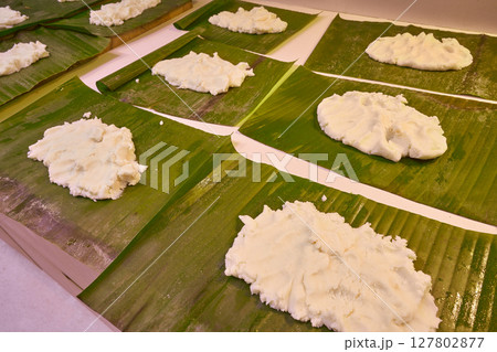Tamale preparation Mexican recipe banana leaves 127802877