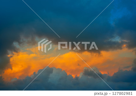 Dramatic clouds at sunset orange sky Dramatic clouds at sunset orange sky 127802981