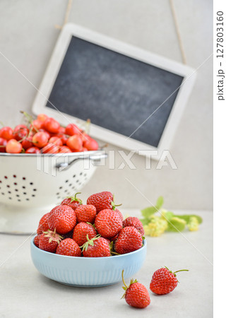 Strawberry and sweet cherry with framed chalkboard Strawberry and sweet cherry with framed chalkboard 127803160