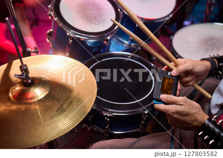 Dynamic Drummer Vibrantly Playing at a Live Music Event with High Energy and Excitement 127803582