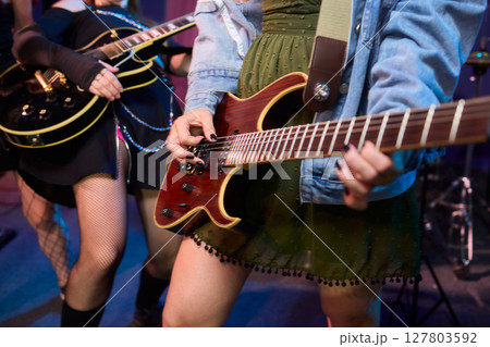 An Energetic and Enthralling Guitar Performance by Trendy Musicians on a Vibrant Stage 127803592