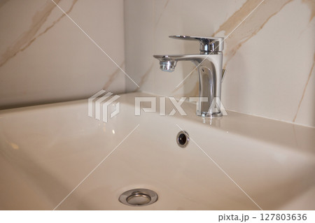 Explore trends in Modern Bathroom Faucet and Tub Design, focusing on elegance and style 127803636