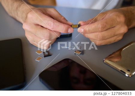 Detailed Process of Installing a SIM Card Utilizing Various Smartphone Components and Accessories Detailed Process of Installing a SIM Card Utilizing Various Smartphone Components and Accessories 127804033