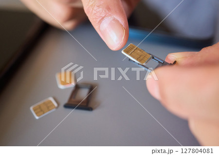 Detailed Process of Installing a SIM Card Utilizing Various Smartphone Components and Accessories 127804081