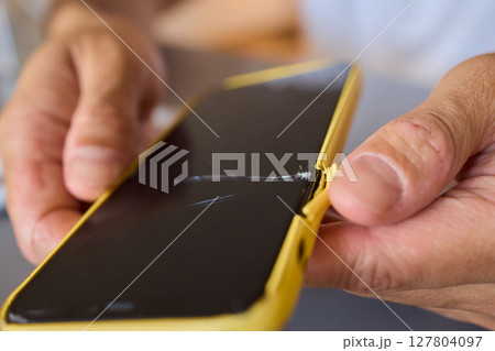 The detailed process for repairing a damaged smartphone screen includes various steps and tools 127804097