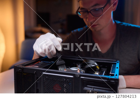 Cleaning a processor fan with a brush 127804213